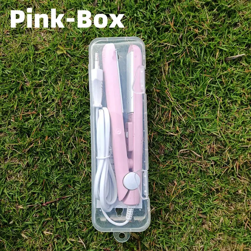 Pink hair straightener or flat iron in a clear plastic case.