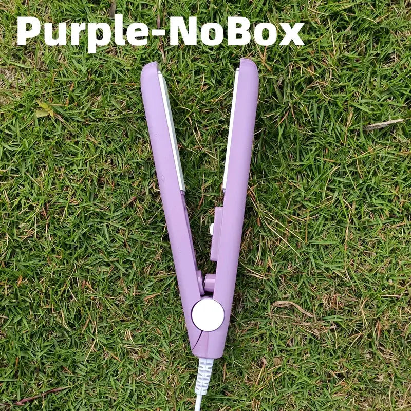 Purple hair straightener lying on grass.