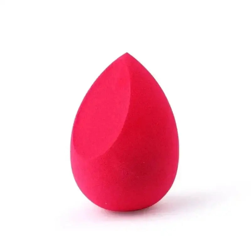 Bright pink, teardrop-shaped makeup sponge or beauty blender.