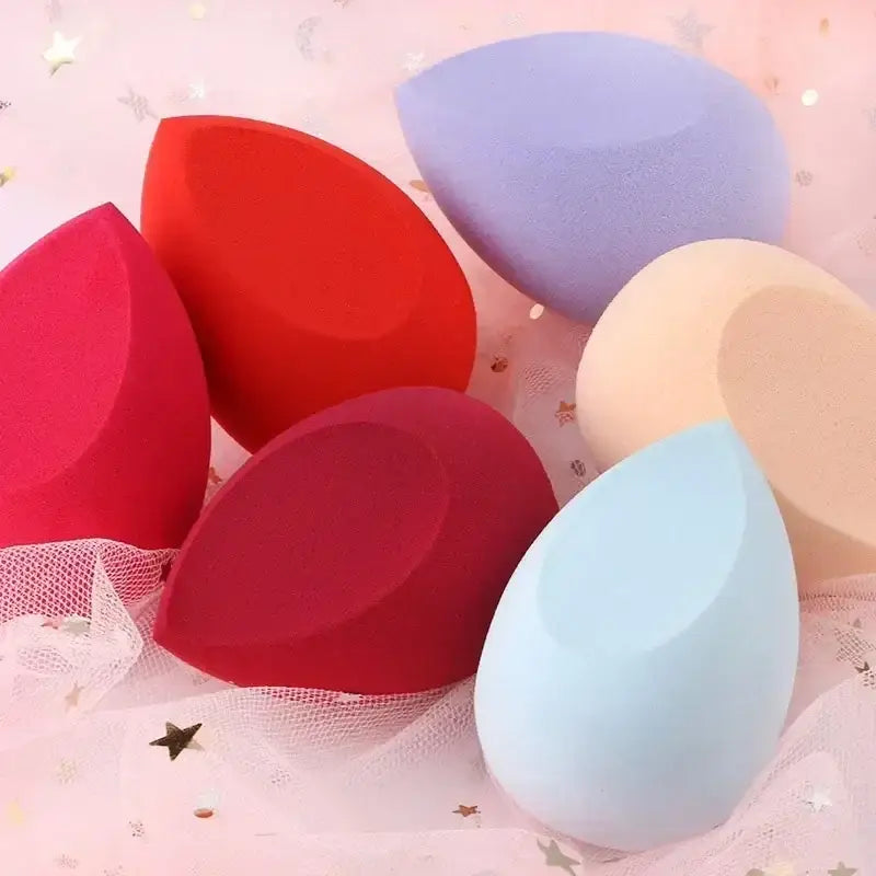 Colorful makeup sponges or beauty blenders in various shapes.