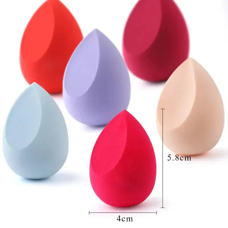 Teardrop-shaped makeup sponges in various pastel colors.