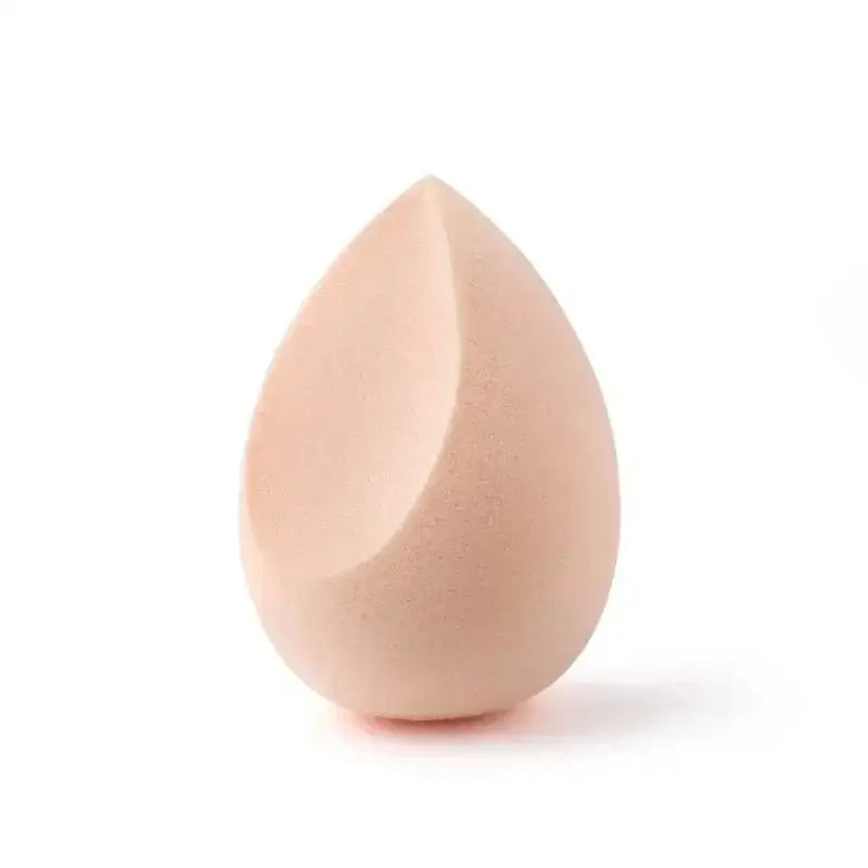 Teardrop-shaped makeup sponge in a pale peach color.