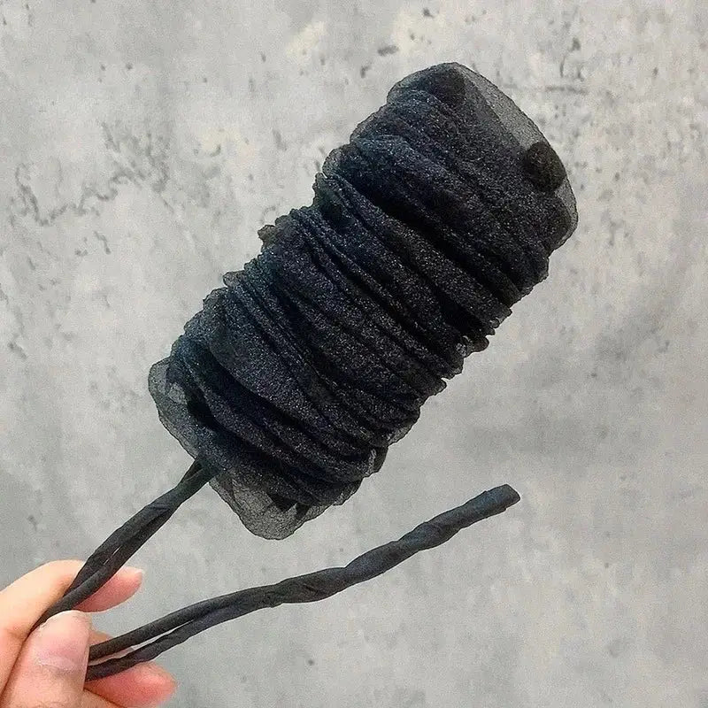 Charred, cylindrical object resembling a burnt marshmallow on a stick.