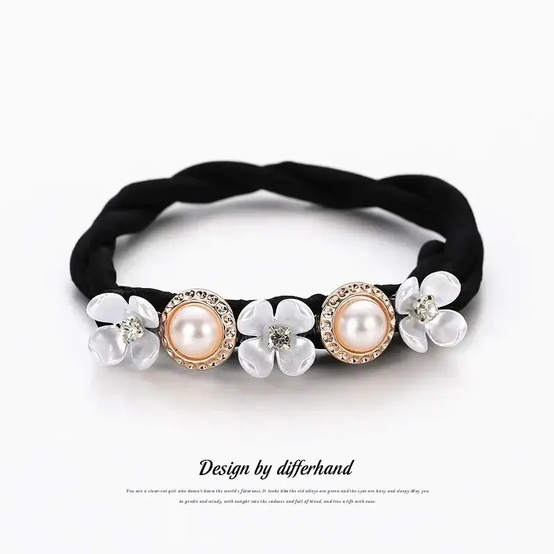 Decorative black elastic hair tie with pearl and flower embellishments.