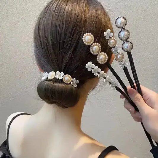 Elegant updo hairstyle adorned with pearl and crystal hair accessories.