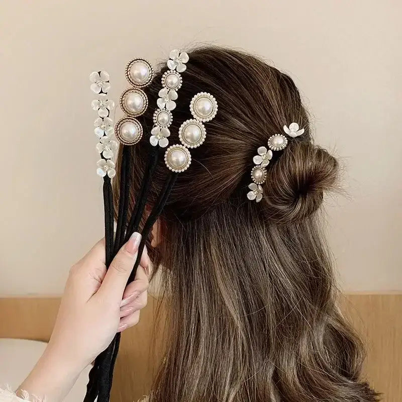 Ornate pearl and floral hair accessories adorning a half-up hairstyle.