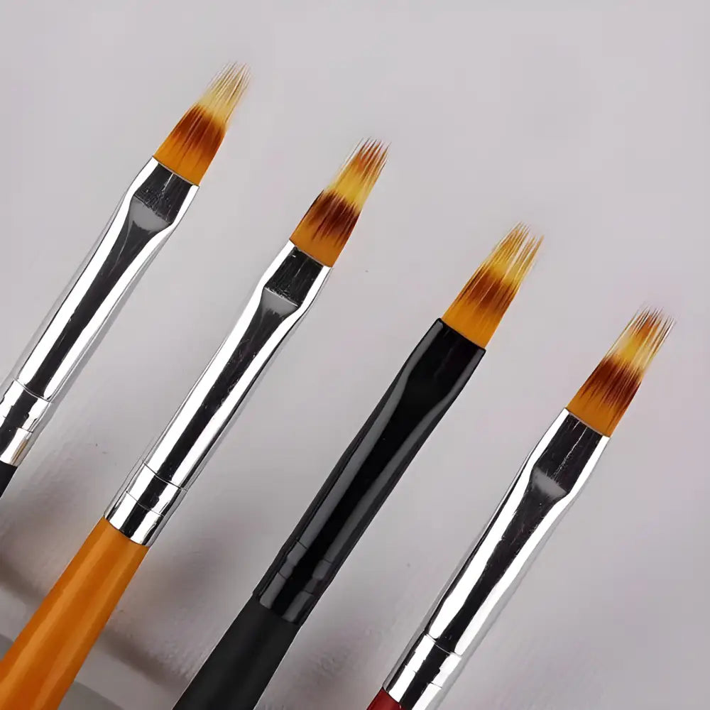 Set of four artist paintbrushes with angled bristles.