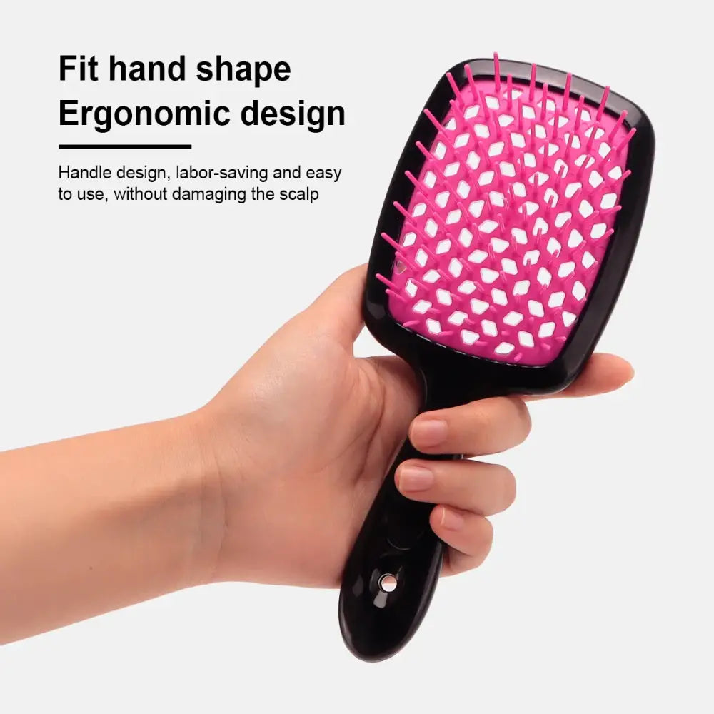 Pink and black hairbrush with an ergonomic handle design.