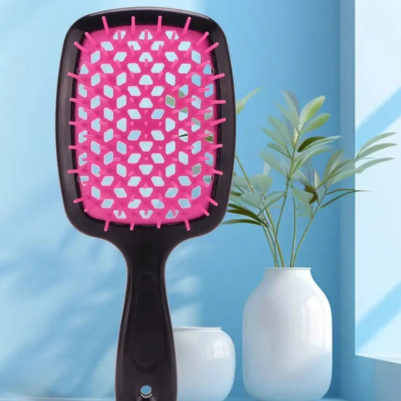 Pink and black paddle hairbrush with a wide rectangular head.