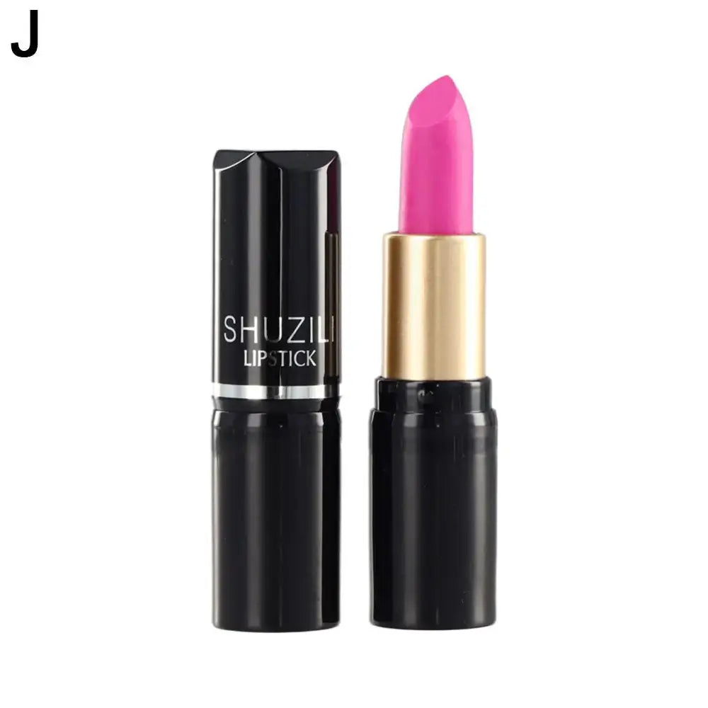 Bright pink lipstick in a black and gold tube.