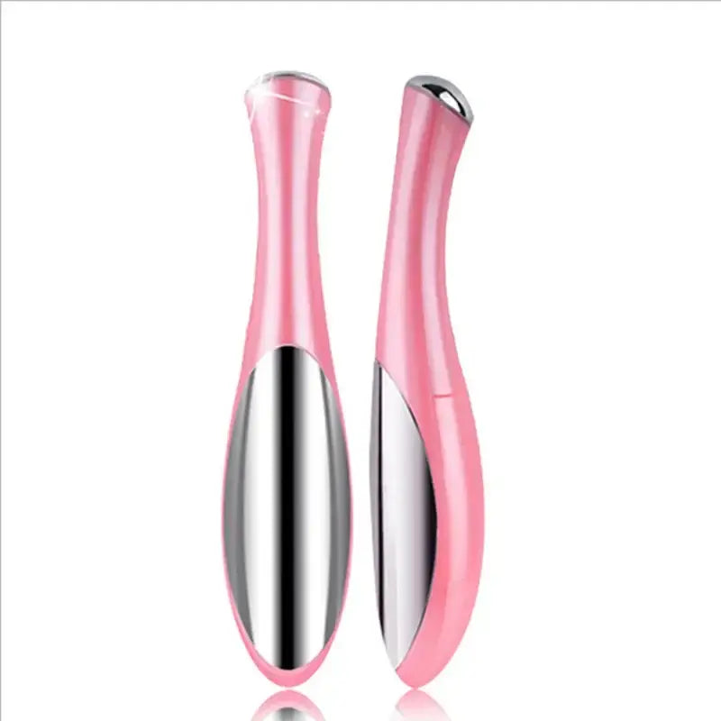 Pink and silver electric eye massager or beauty device with curved ergonomic shape.