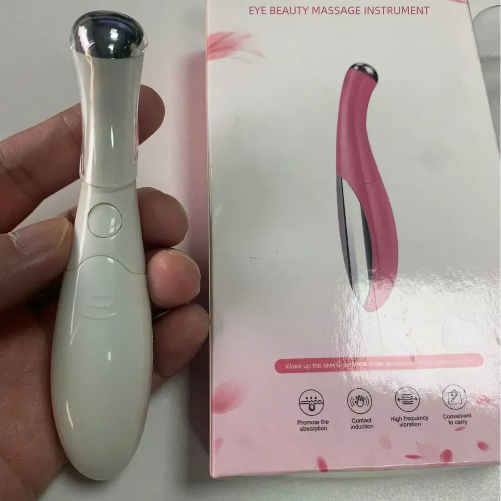 Eye beauty massage instrument with a white handheld device and pink packaging.