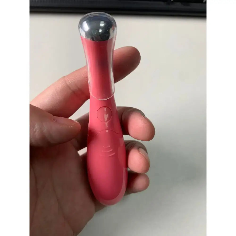 Pink vibrator with a rounded silver tip.