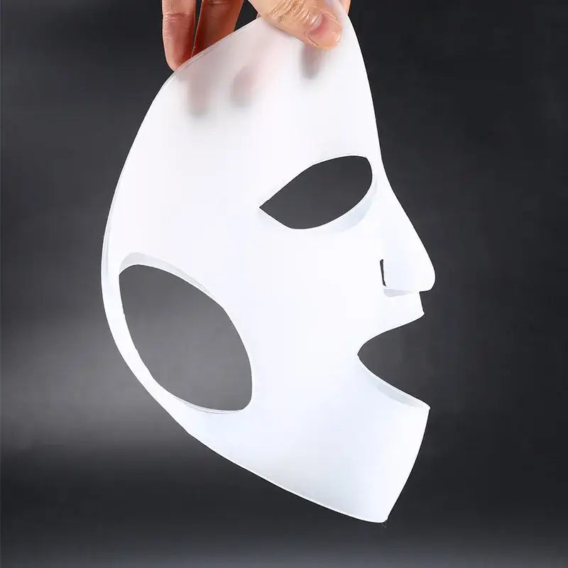 White facial mask with large eye and mouth openings.