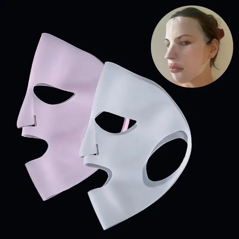 Two theatrical masks, one pink and one white, positioned side by side.