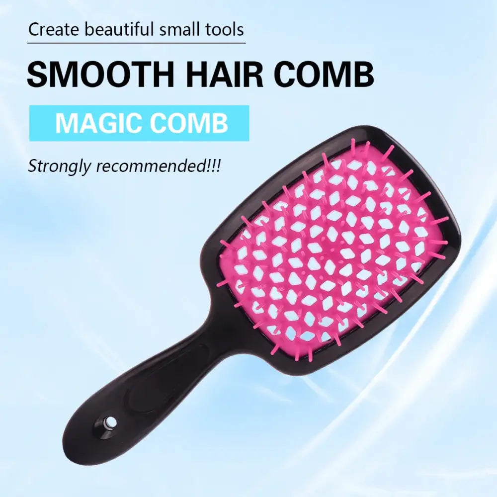 Pink and black paddle brush with white polka dots on its cushioned surface.