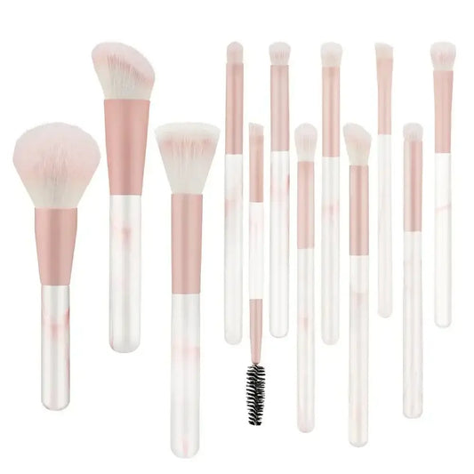 Set of makeup brushes with pink and white handles.