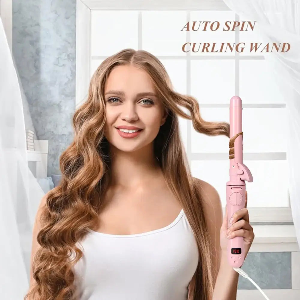 Pink auto spin curling wand held by a woman with long, wavy blonde hair.