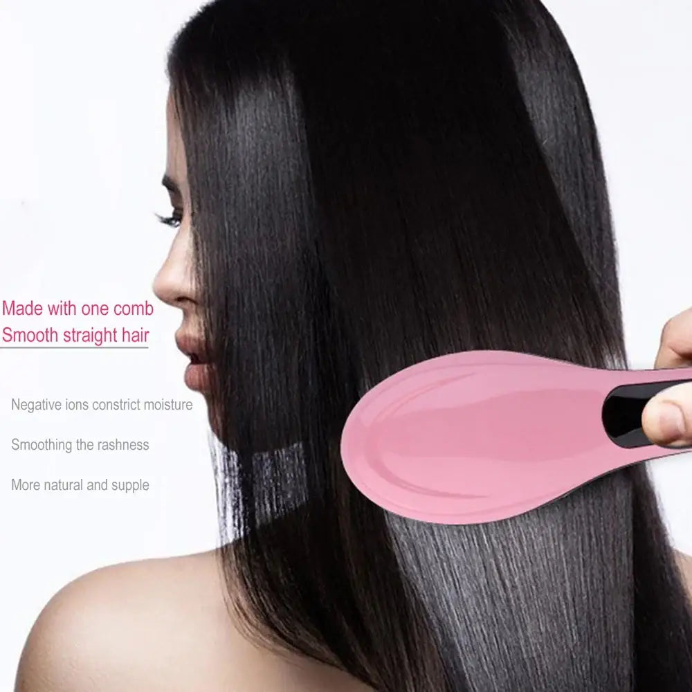 Pink electric hair straightening brush being used on long, dark hair.