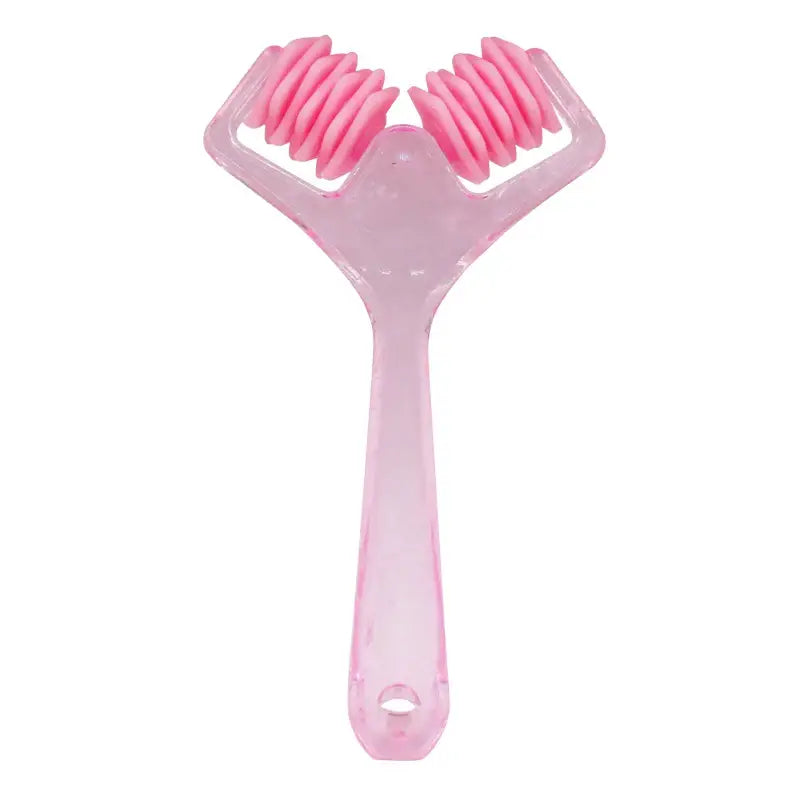 Pink plastic facial massage roller with dual spiked wheels.