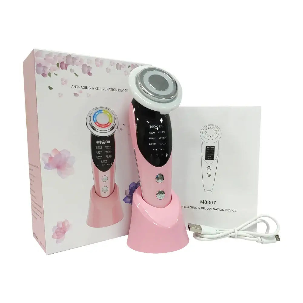 Pink and white handheld beauty device with multiple attachments and a charging base.