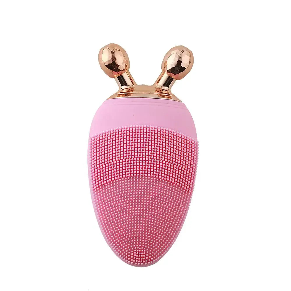 Pink egg-shaped facial cleansing brush with gold bunny ear-like protrusions on top.