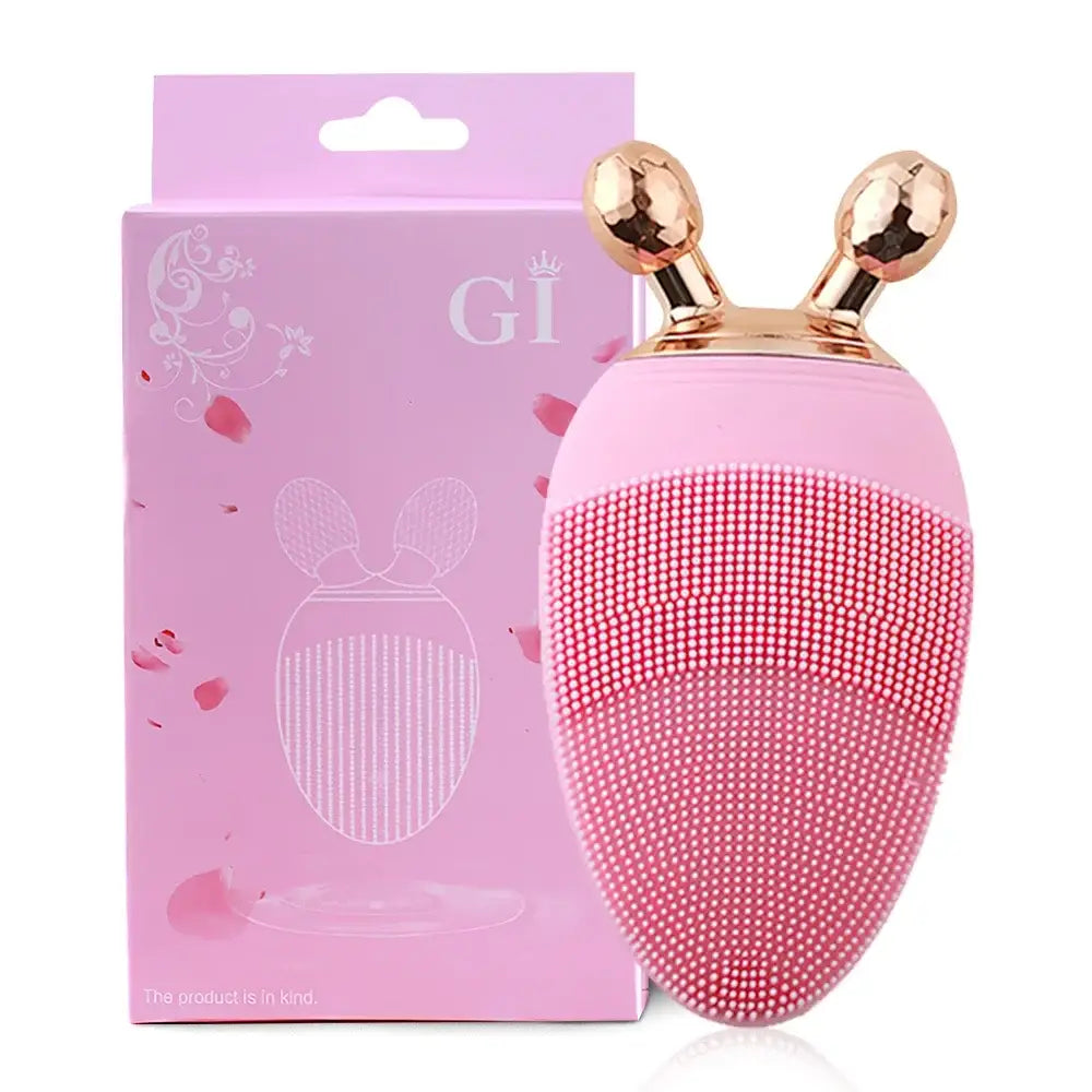 Pink silicone facial cleansing brush with gold-colored bunny ear-like protrusions on top.