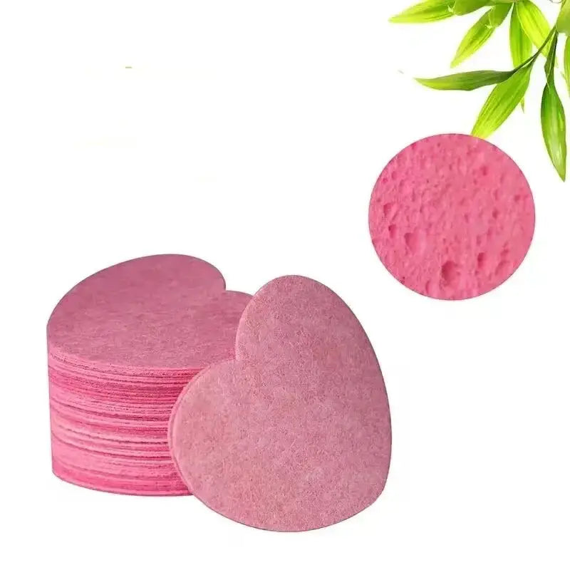 Heart-shaped pink sponges or cleansing pads stacked together.