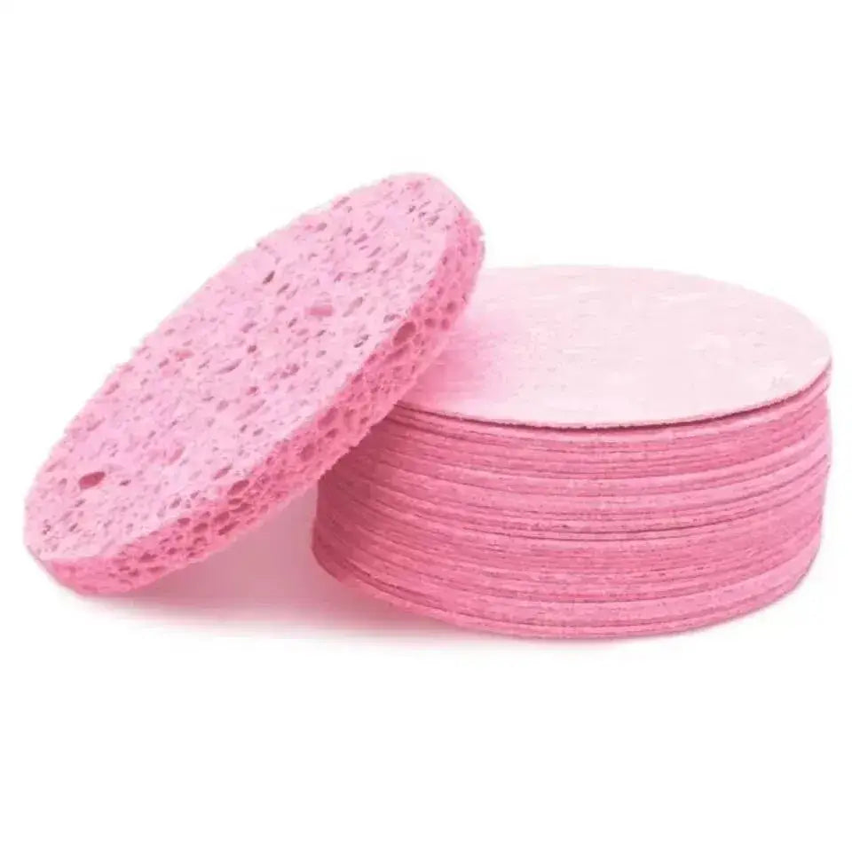 Pink facial cleansing sponges stacked together.