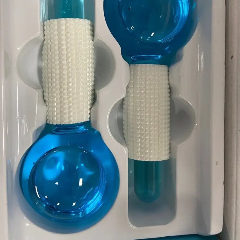 Blue glass bulb-shaped objects with textured white grips attached to a surface.