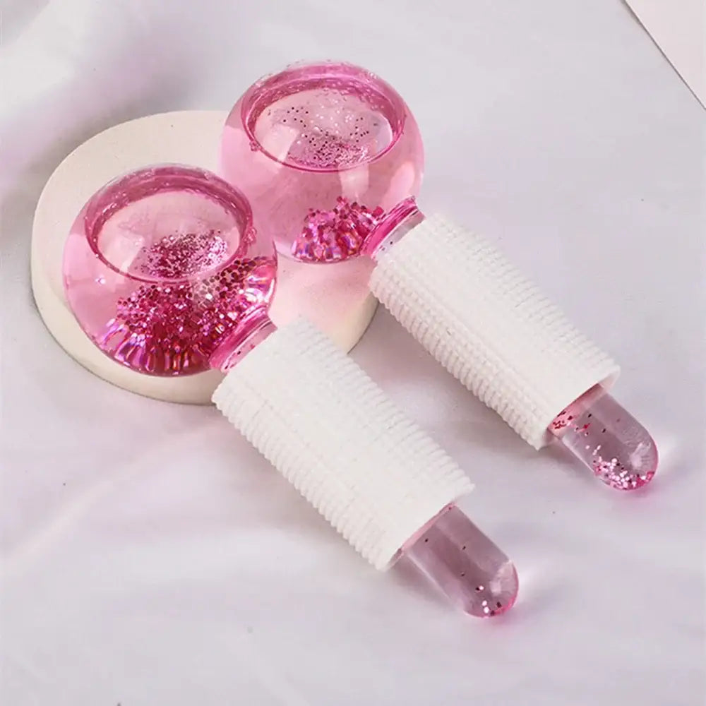 Pink ice roller facial massage tool with glitter-filled liquid chambers.