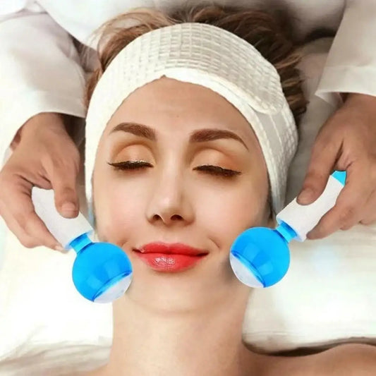 Woman receiving a facial treatment with blue handheld devices applied to her cheeks.