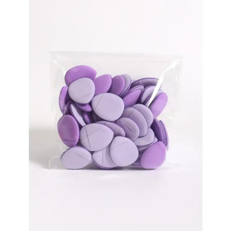 Clear plastic bag filled with purple candy melts or chocolate discs.