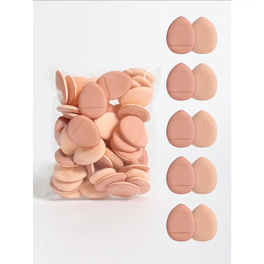 Pile of flesh-colored, egg-shaped makeup sponges or beauty blenders.