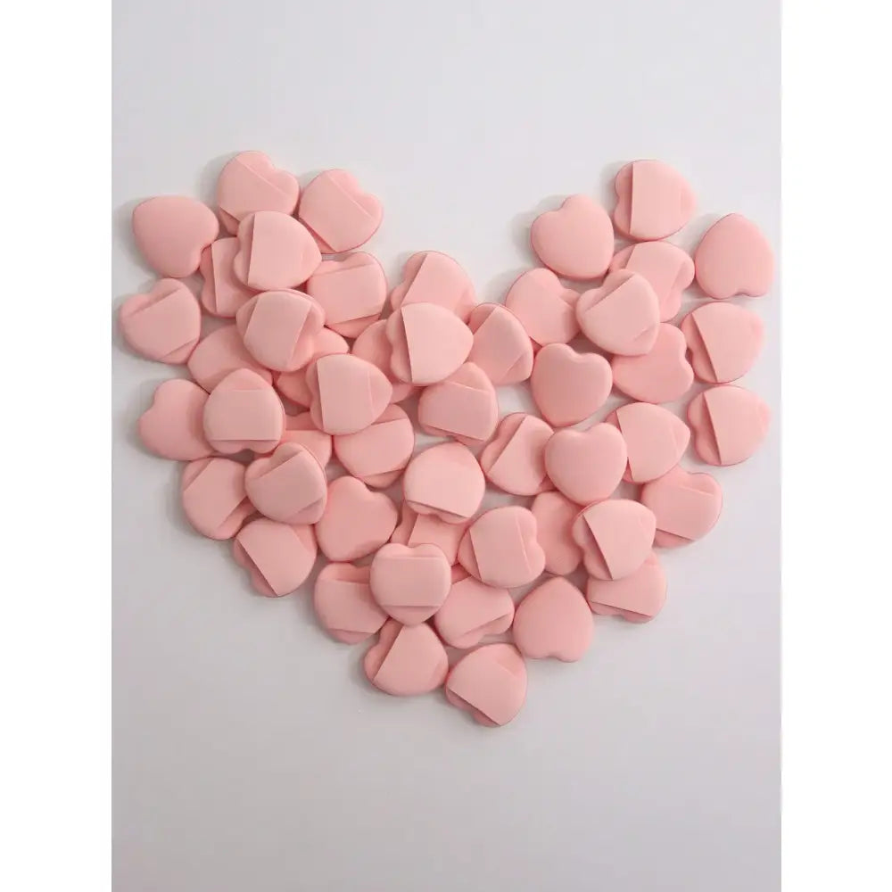 Heart shape formed by multiple small pink heart-shaped objects.