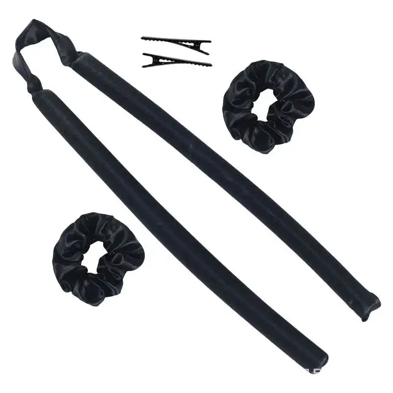 Two long black fabric-covered foam hair rollers with accompanying hair clips and scrunchies.