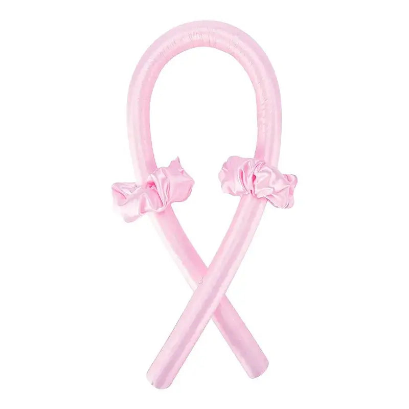 Pink ribbon-shaped hair accessory with bows at each end.