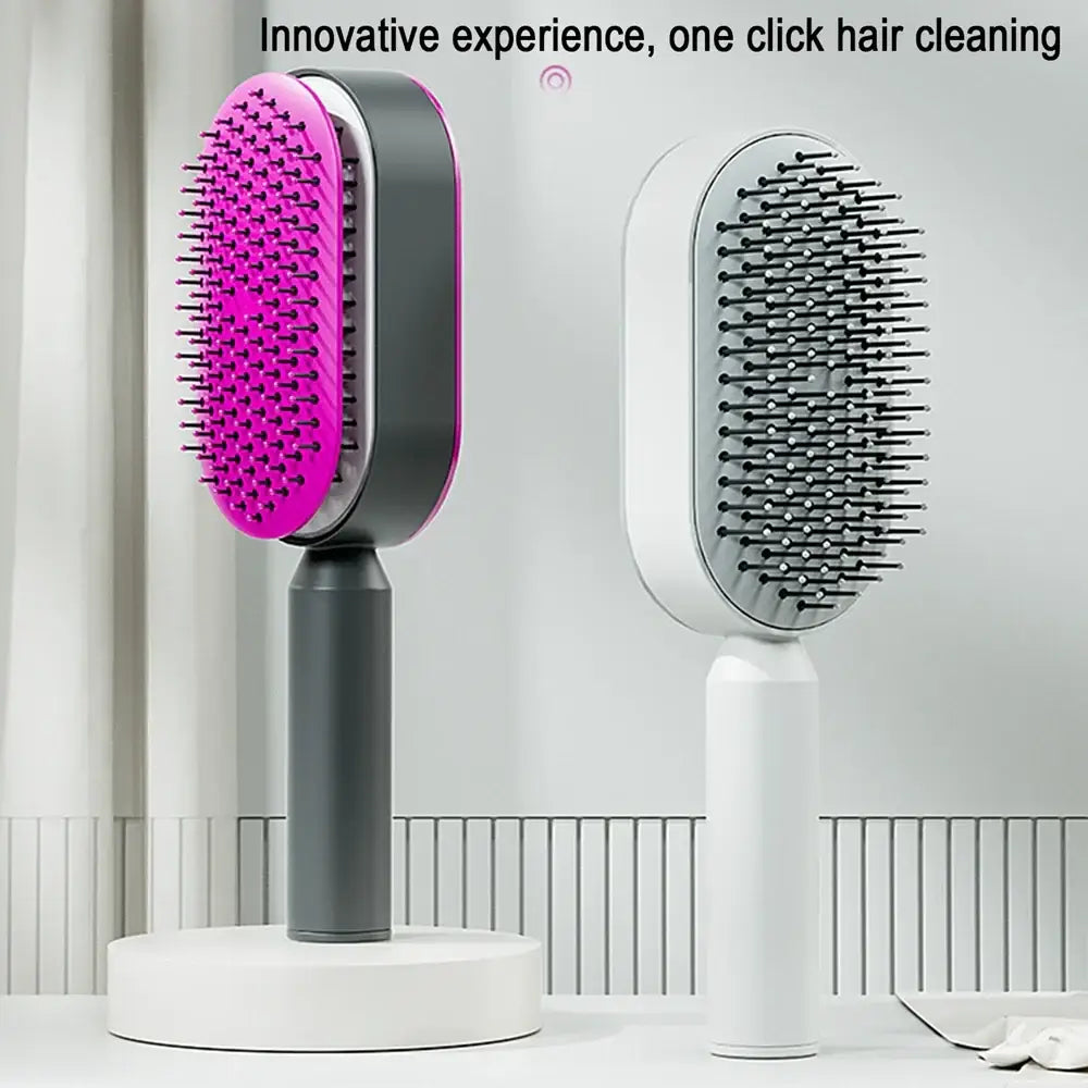 Electric hair brush with a vibrant pink bristle pad and dark gray handle.