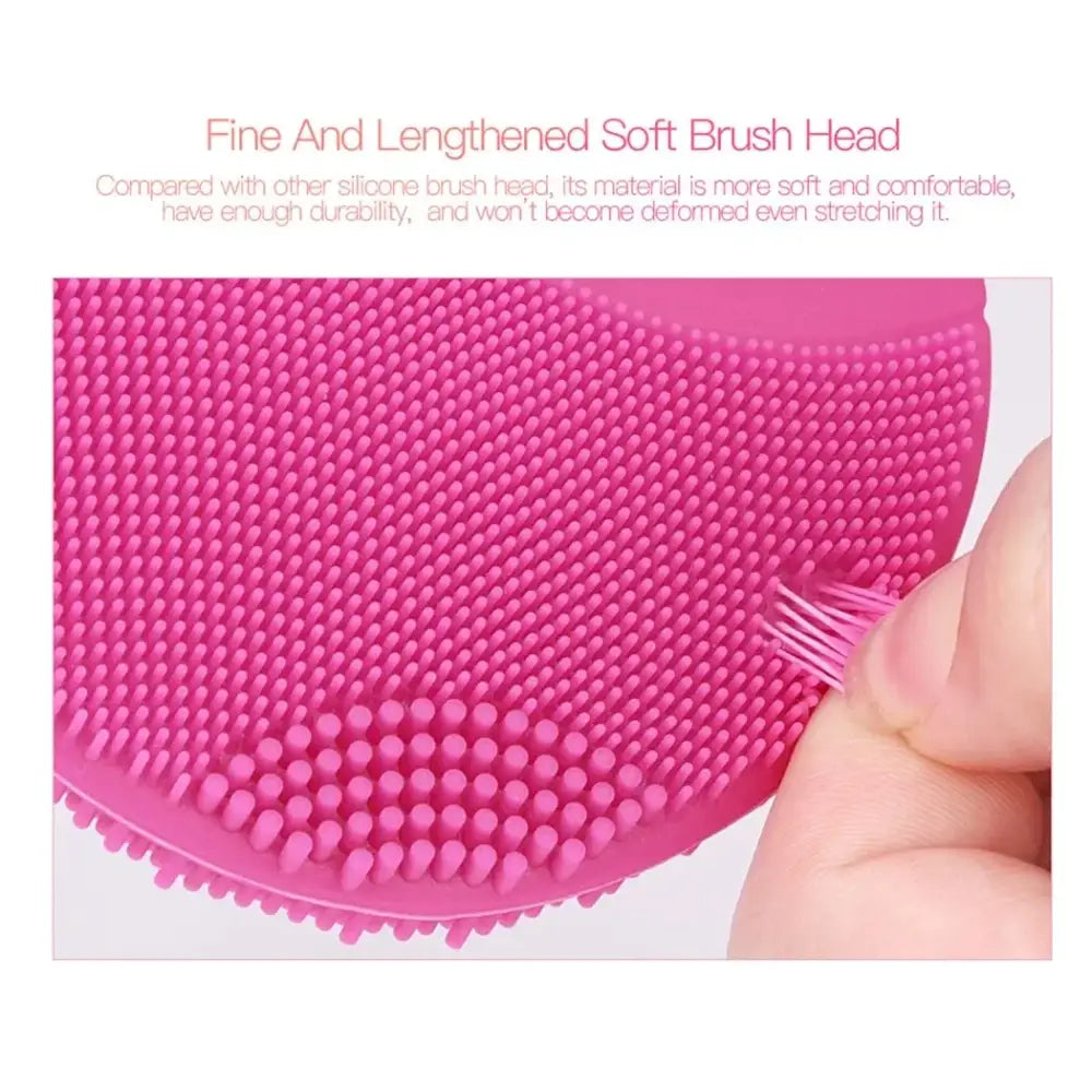 Pink silicone facial cleansing brush with fine, soft bristles.