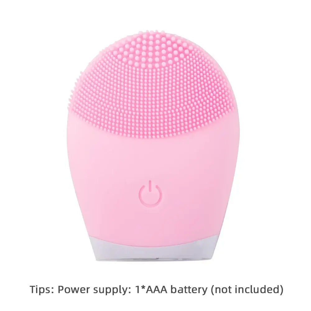 Pink silicone facial cleansing brush with textured bristles and a power button.