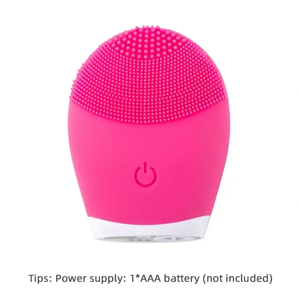 Bright pink silicone facial cleansing brush with textured bristles and a power button.