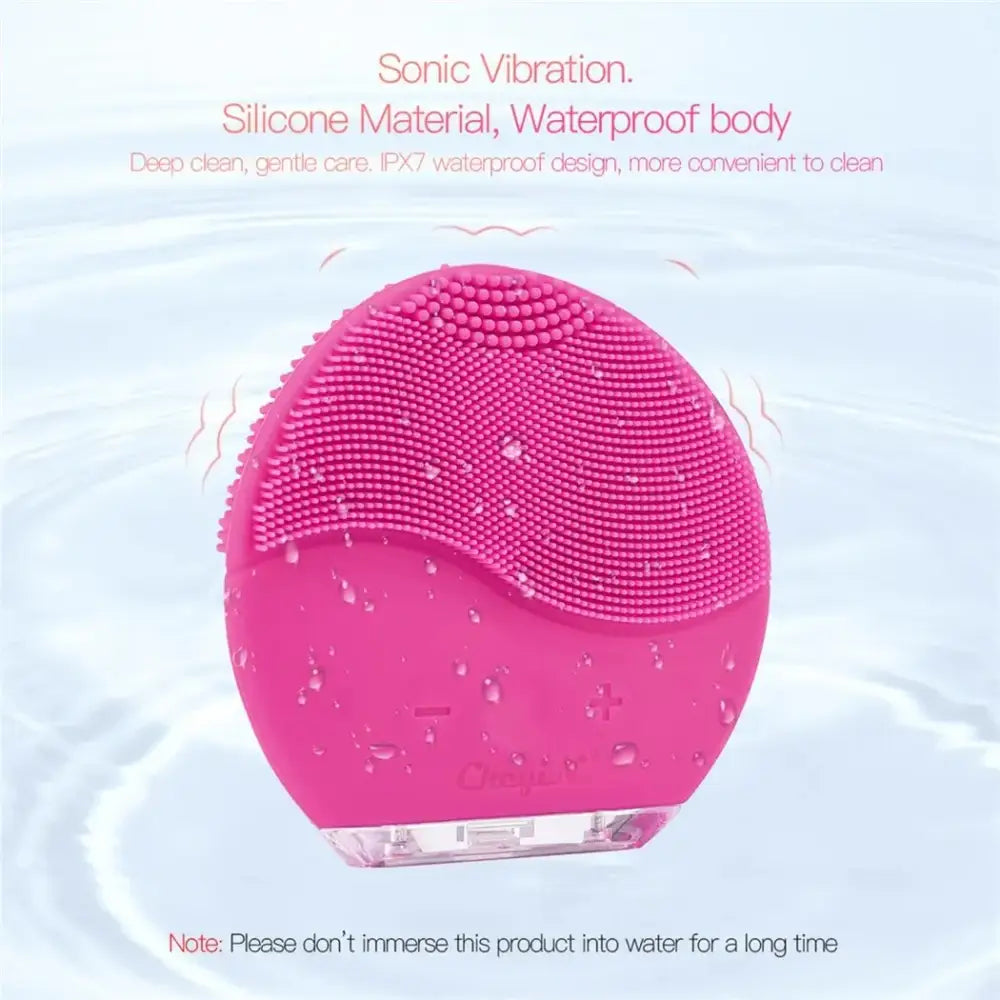 Pink silicone facial cleansing device with textured surface and sonic vibration technology.