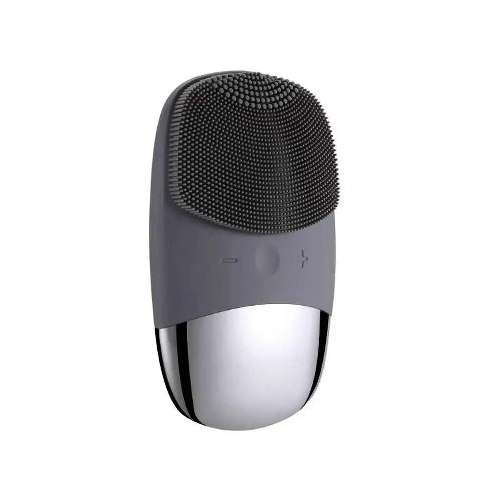 Facial cleansing brush with a gray silicone head and metallic silver base.