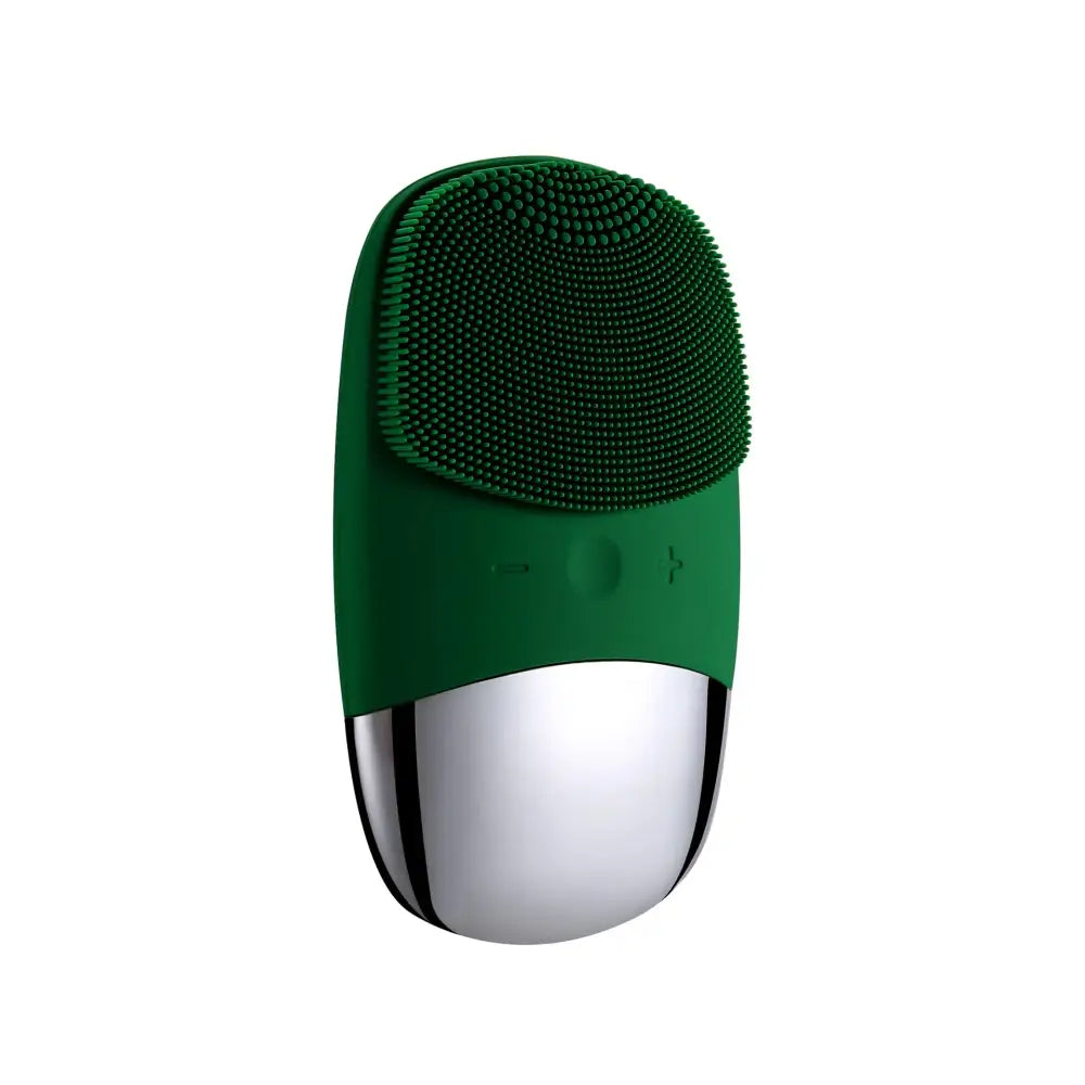 Facial cleansing brush with a green silicone head and metallic silver base.