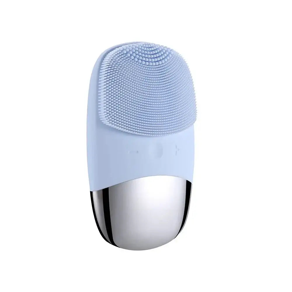 Facial cleansing brush with a light blue silicone head and metallic silver base.