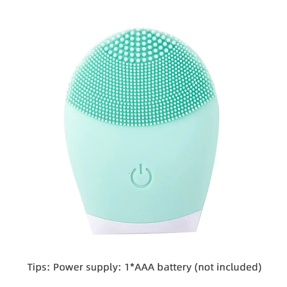 Mint green facial cleansing brush with silicone bristles and a power button.