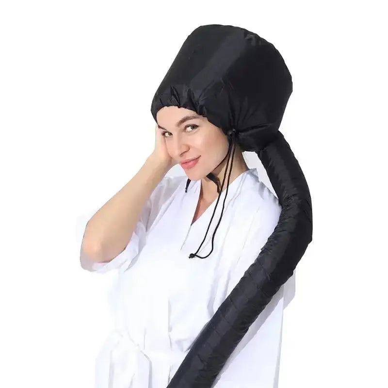 Portable hair dryer bonnet attachment worn by a person in a white top.