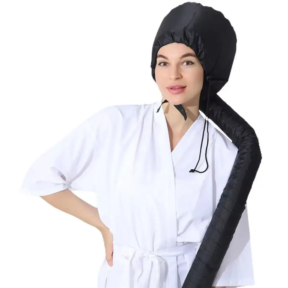 Black head covering with an extended sleeve-like portion worn by a person in medical attire.