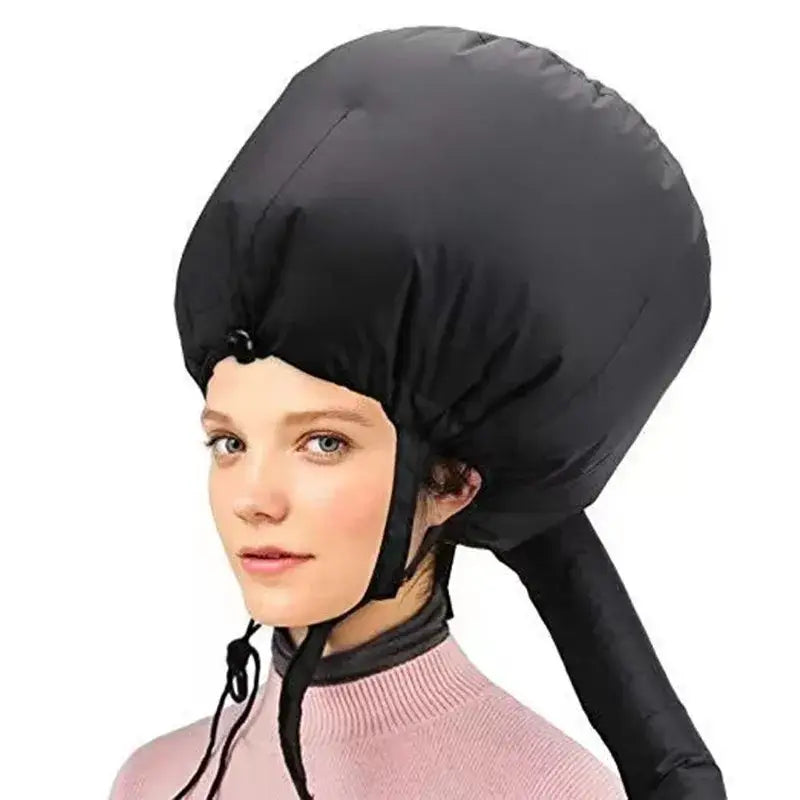 Black inflatable hair drying bonnet worn on a person’s head.