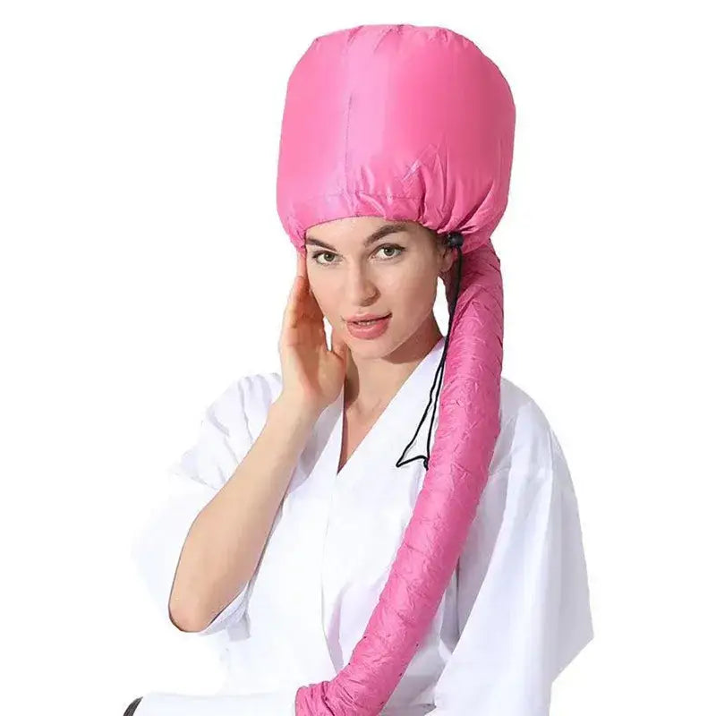 Pink hair dryer bonnet with an attached hose.